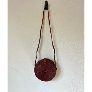 Round rattan leather sling bag.
